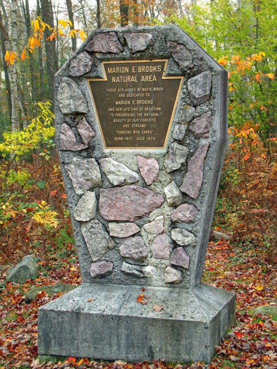 the memorial features many names and a very large rock