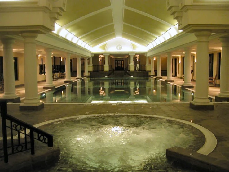 the indoor swimming pool with stone steps leads into the lobby