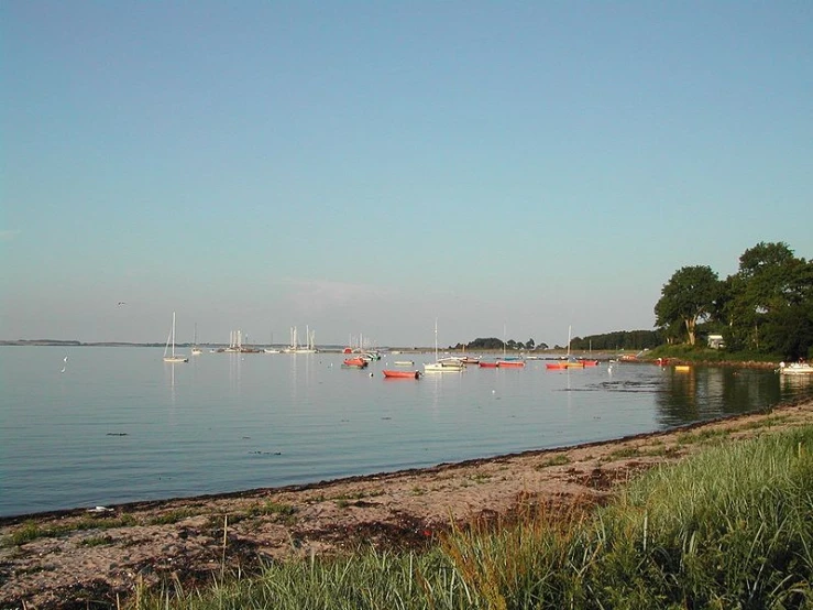 boats are floating on the blue sea waters