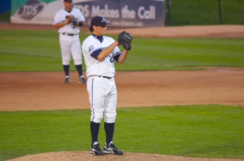 two baseball players standing on a baseball field