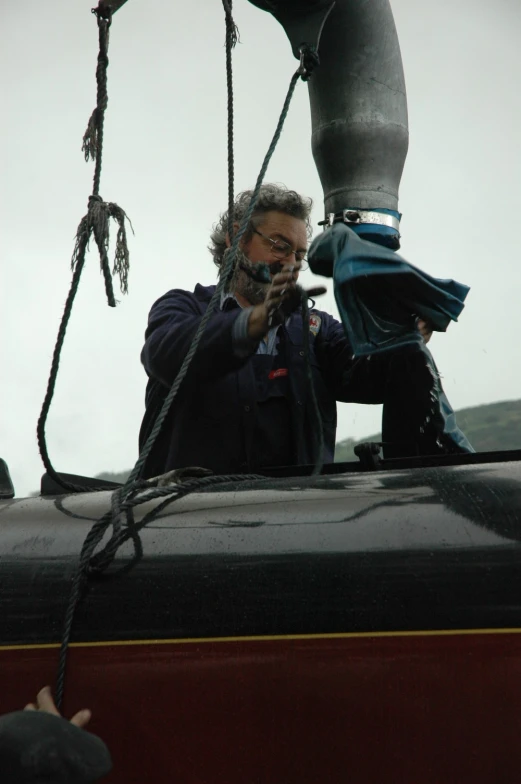 a man in a boat holds his camera up