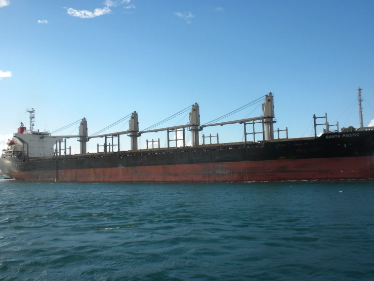 large cargo ship sailing in open water on a sunny day