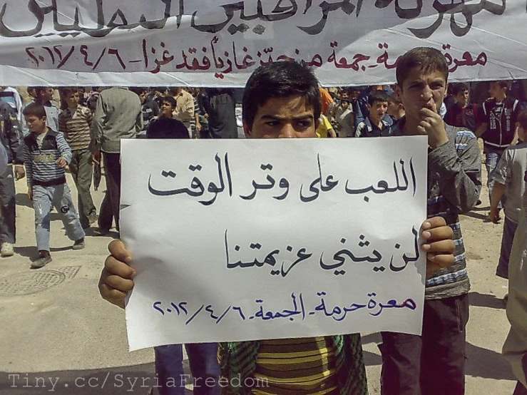 a man holding a sign at a protest