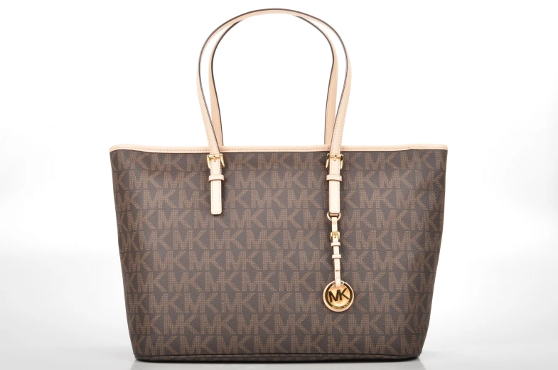 a brown michael korsch tote with a gold charm