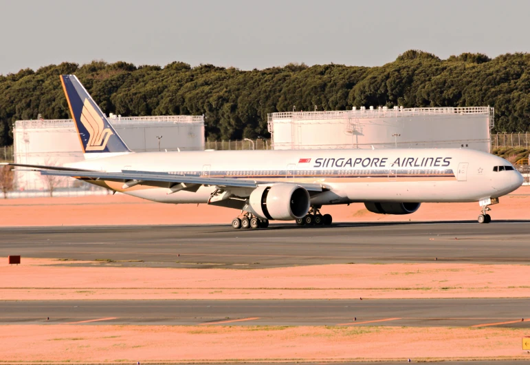 an airplane parked on a runway next to a building