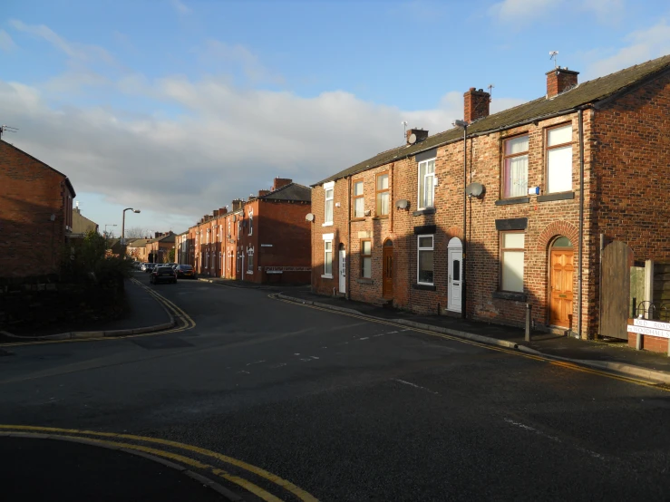 an empty street with old houses near each other