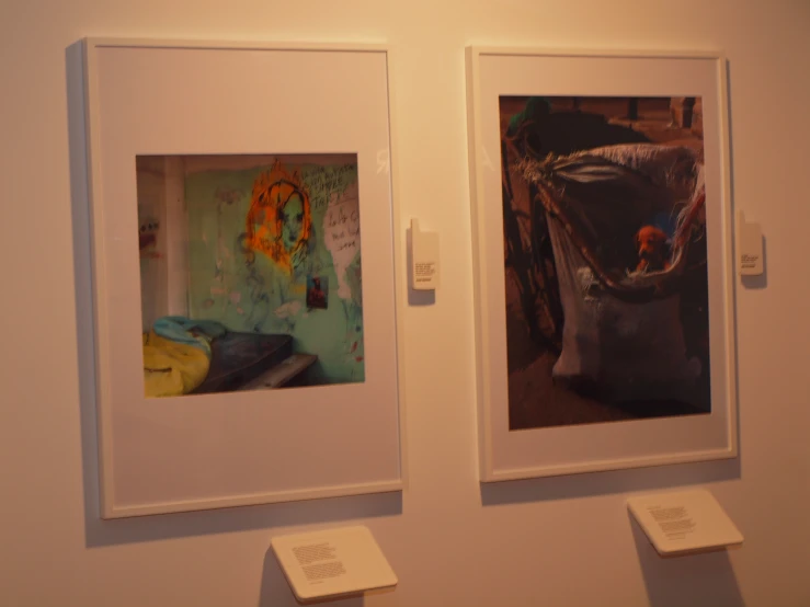 two framed images are on display in the corner