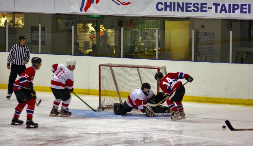 a group of people that are playing ice hockey