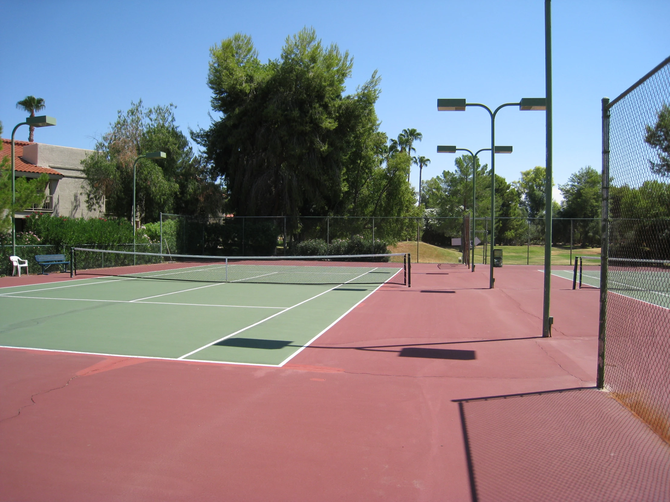 a tennis court with a red floor and white lines