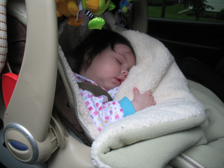 a baby in a car seat being slept down