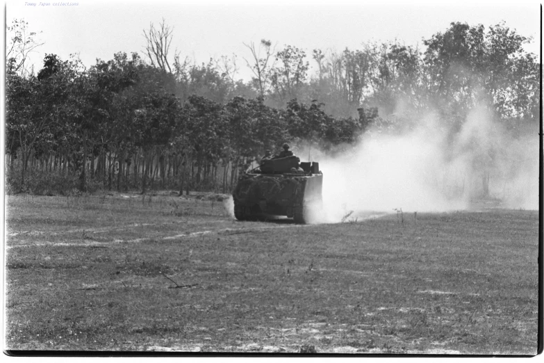 an old black and white po of men in an army vehicle