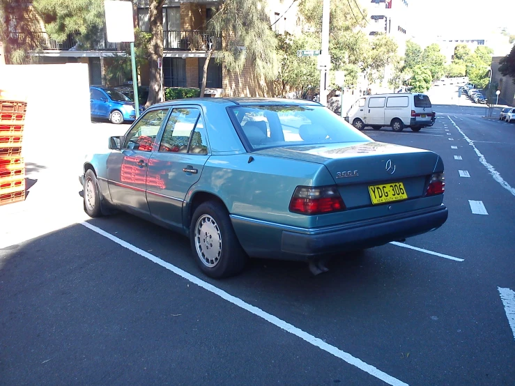 a car parked at a curb of a city street