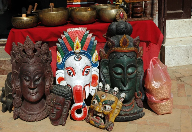 several various types of statues sit outside on display