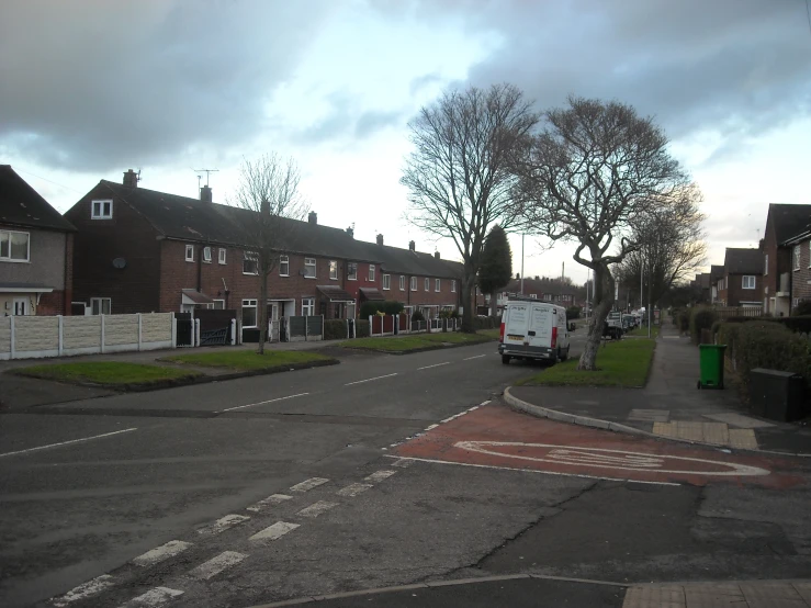 several homes lined with trees and street signs