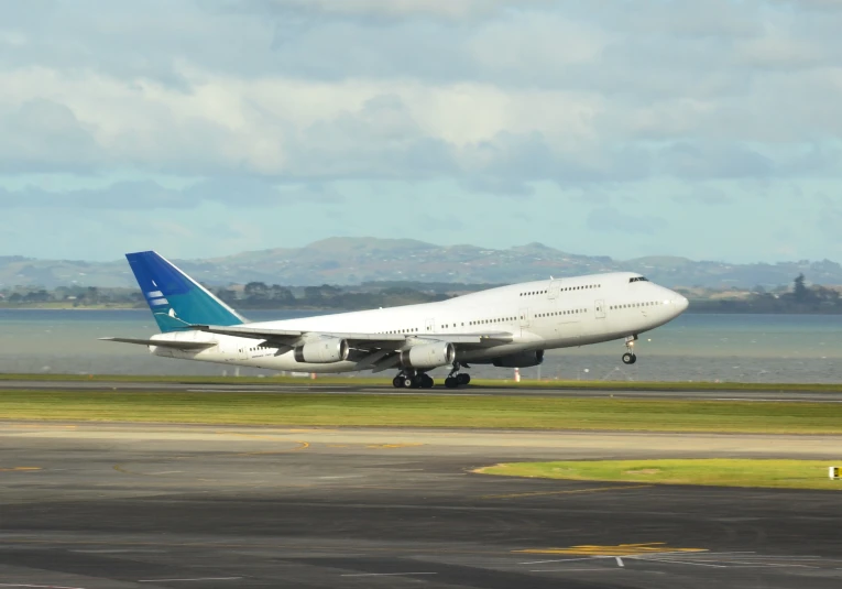 there is a white airplane landing at the airport