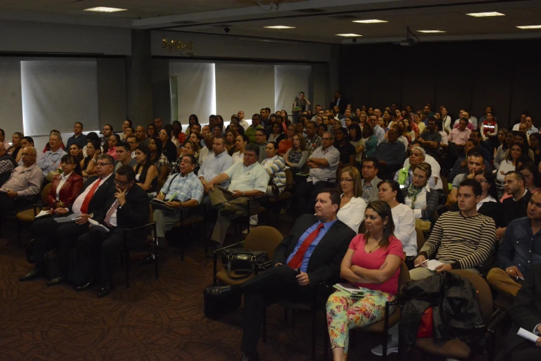 a large crowd is watching the speakers at a conference