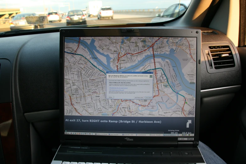 a laptop is sitting on top of the dashboard