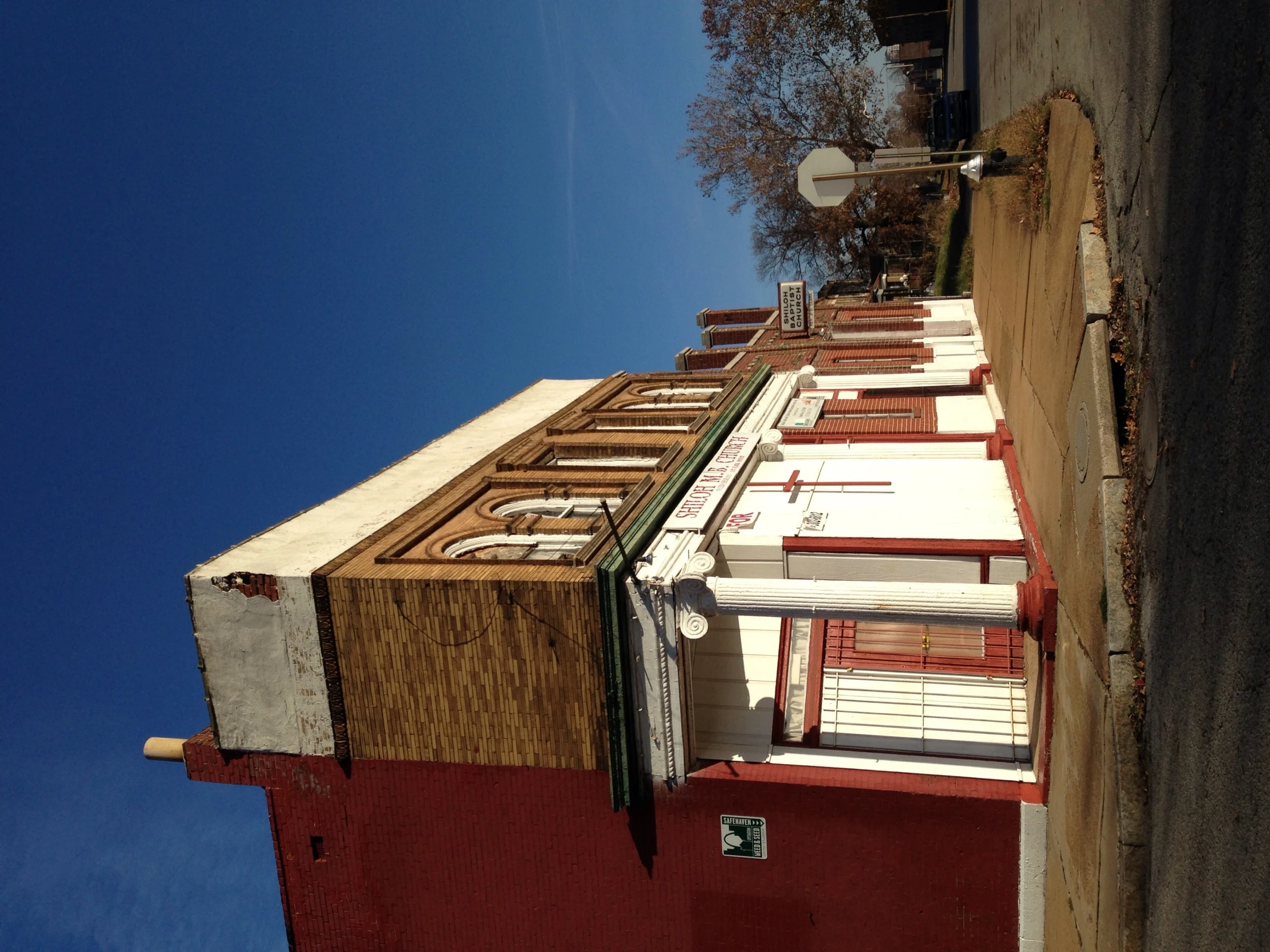 a tall red brick building sitting next to a street