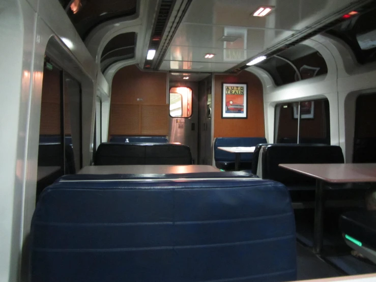 a large train car has many seats with a table