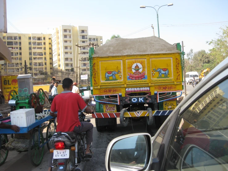 two motorcycles and a vehicle in the middle of a busy road