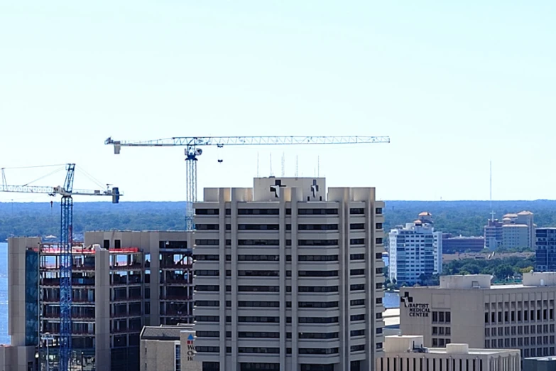 a large clock tower sitting next to tall buildings