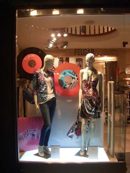a couple of mannequins in a store window