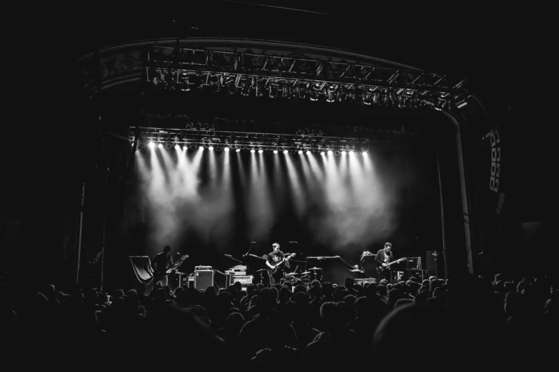 a stage full of people while playing musical instruments