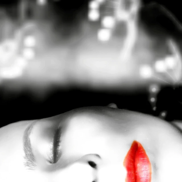 a woman has a bright red lip in black and white