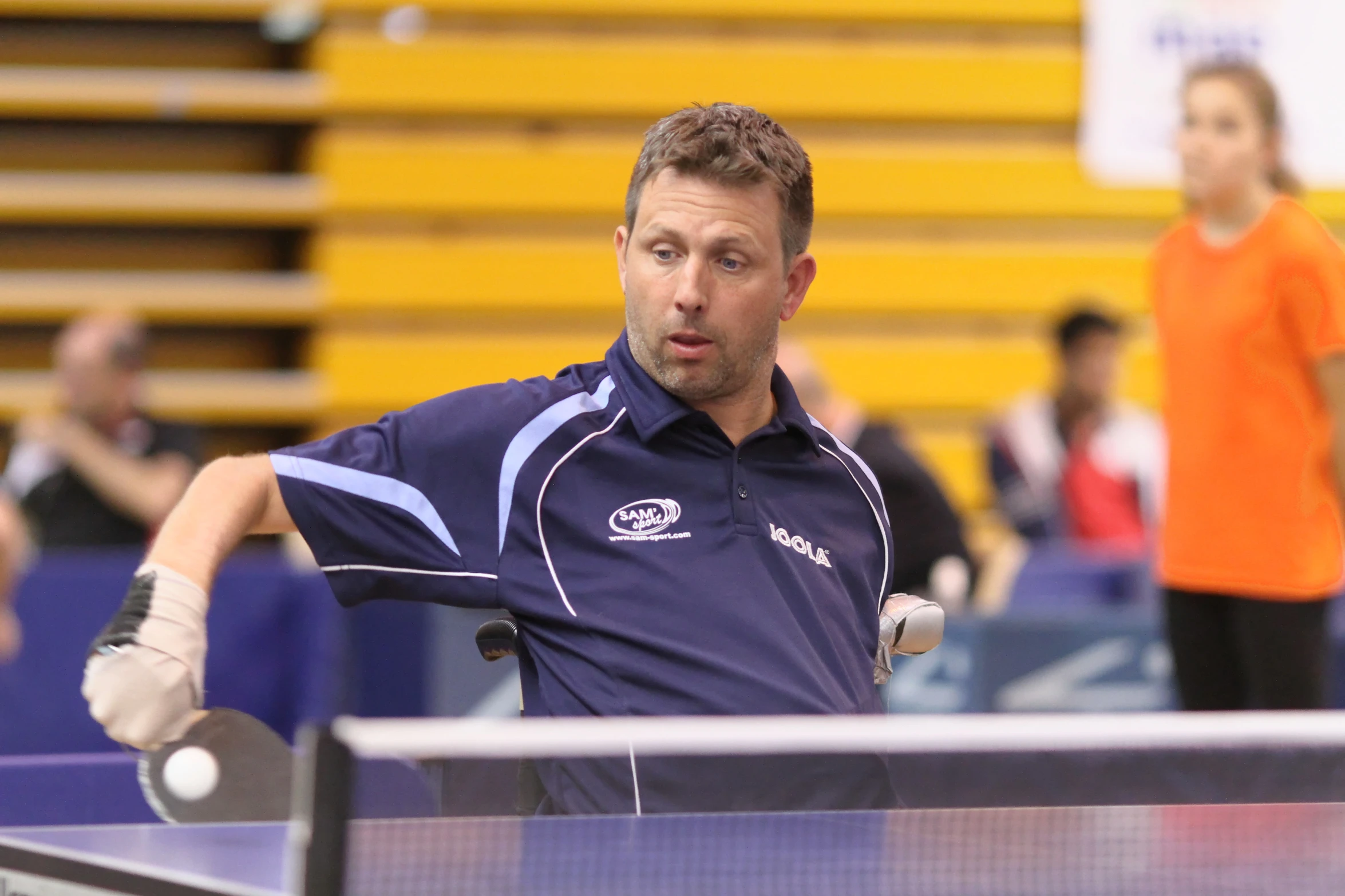 a man holding a table tennis racket in his hand