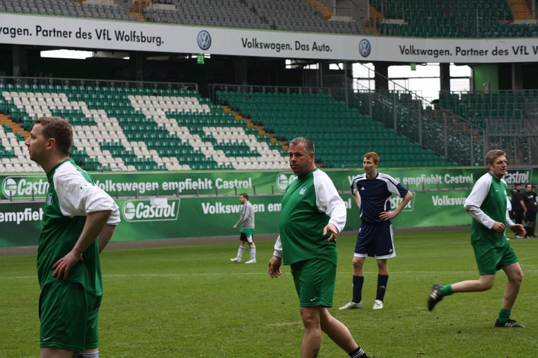 a group of men playing soccer on a field