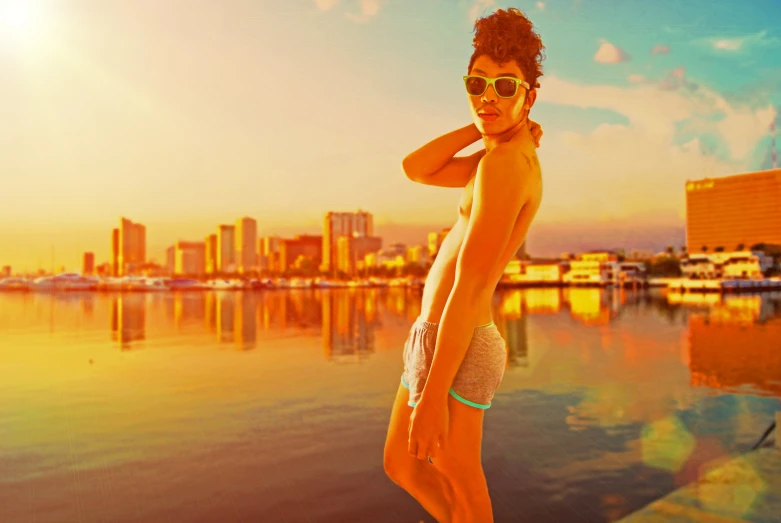 a woman wearing sun glasses while standing on the edge of the pier