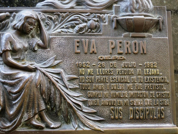 a bronze plaque is engraved into the cement wall