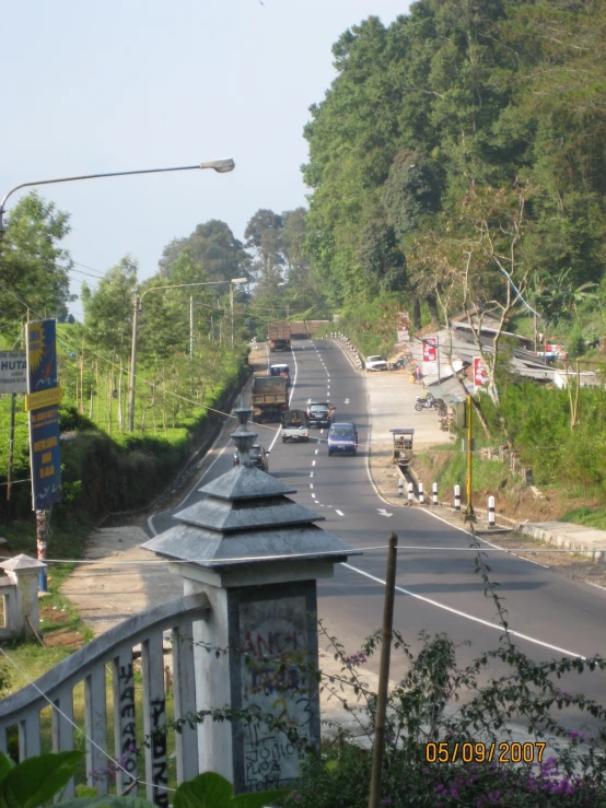 a road with vehicles going down the hill