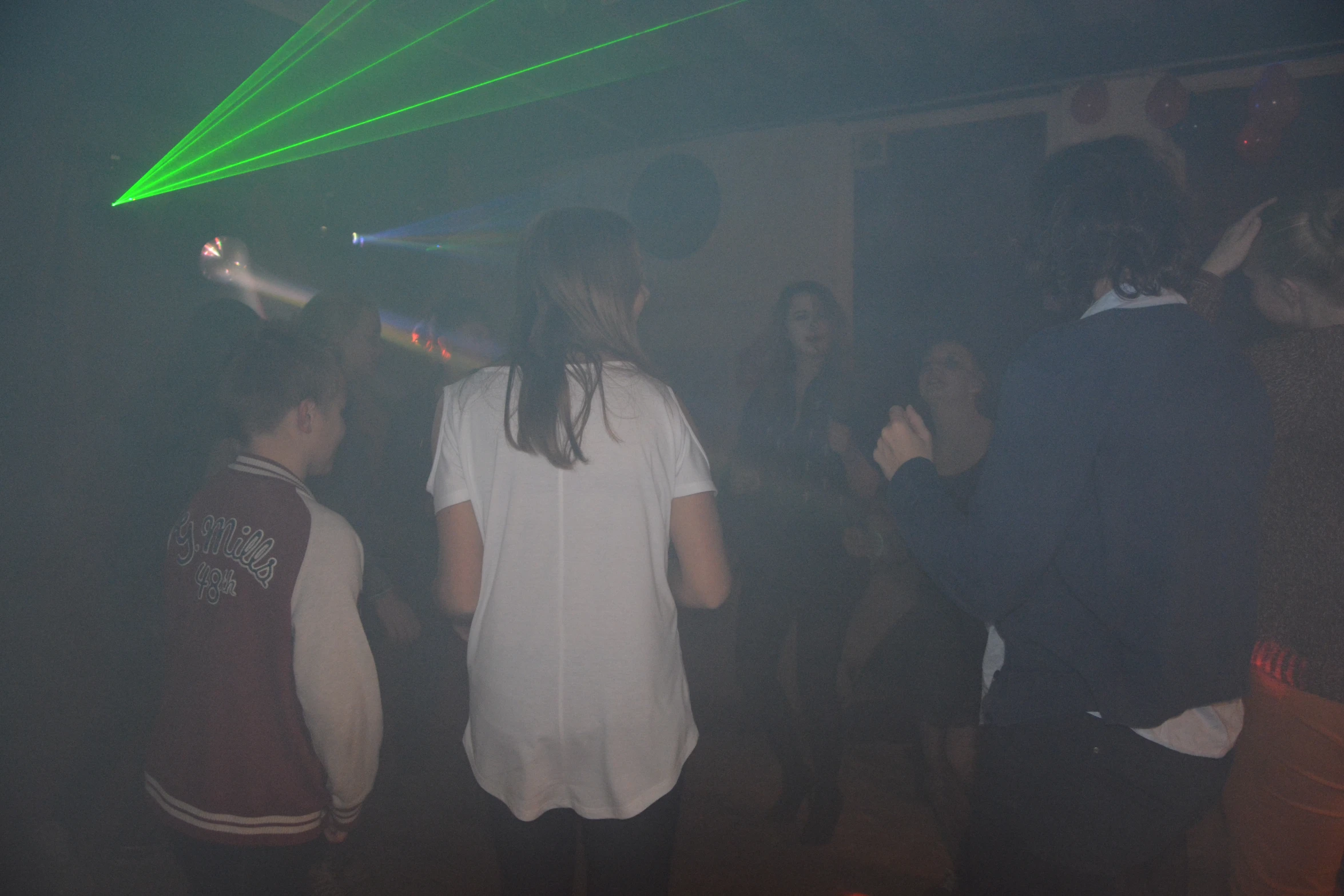 a crowd of people are standing around a bar