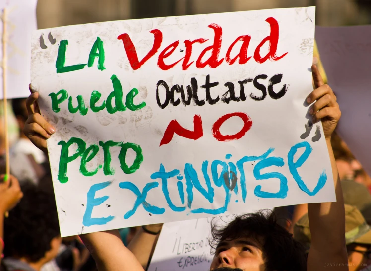 a group of people holding signs during a demonstration