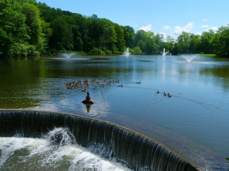 a man rides a boat near a waterfall