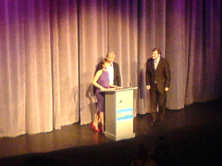 a couple of people that are standing in front of a podium