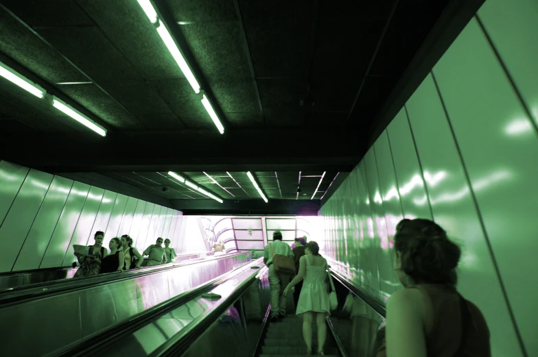 a woman in a dress on a escalator in a building