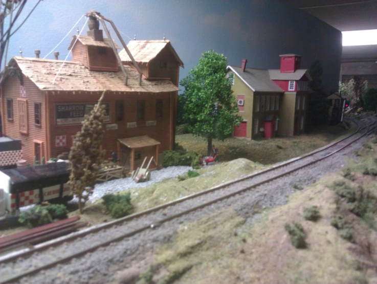 a toy train set on display next to a building