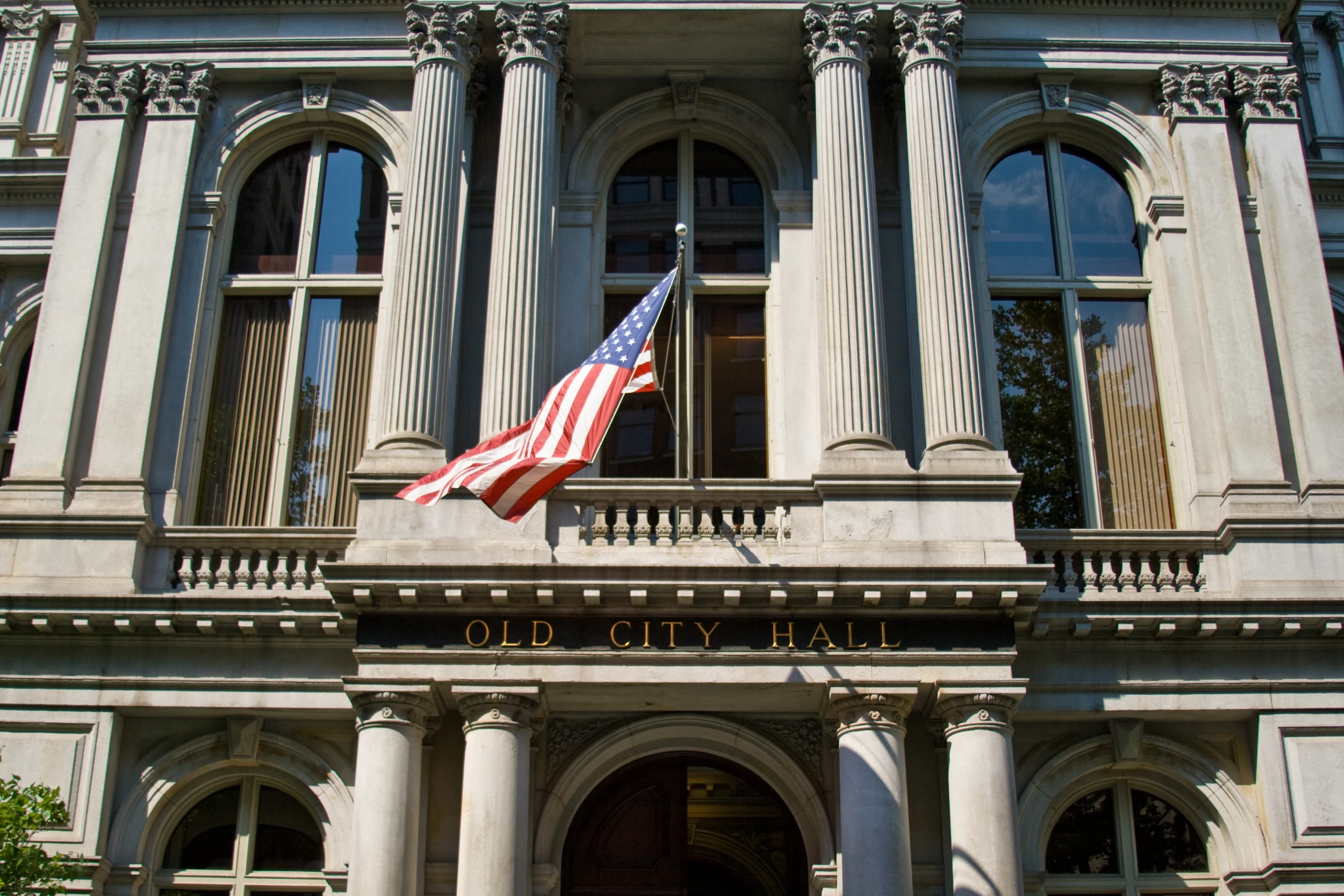 a large white building with an american flag on top