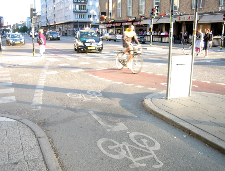 a person on a bicycle riding down a street