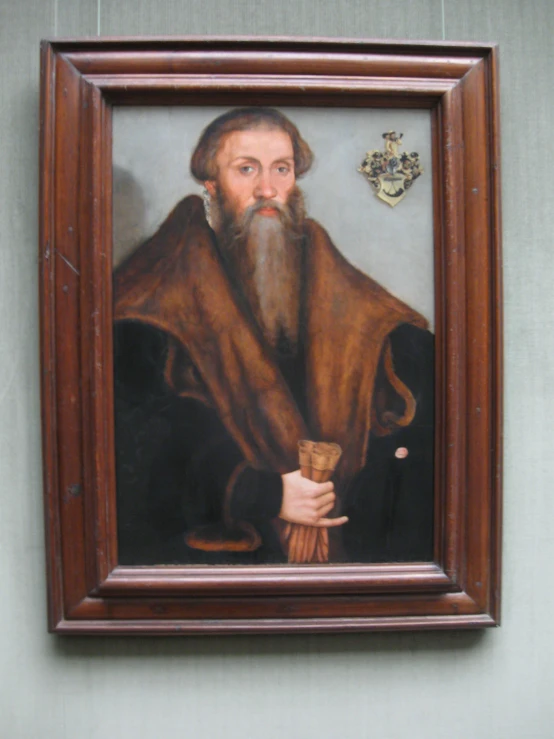 a painting of an older man is hanging on a wall