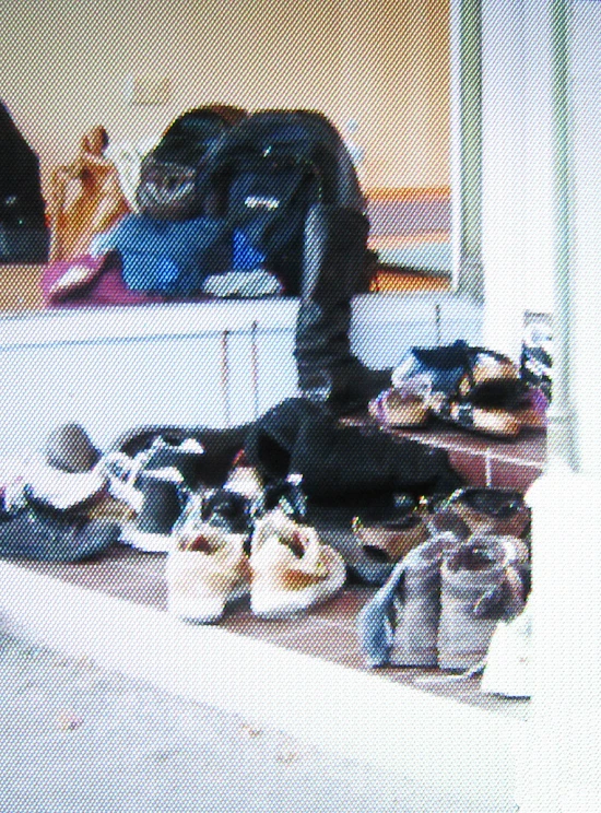 a large pile of shoes on a wooden floor