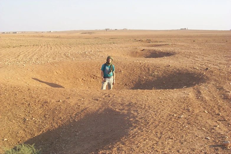 a person is standing in a desert area