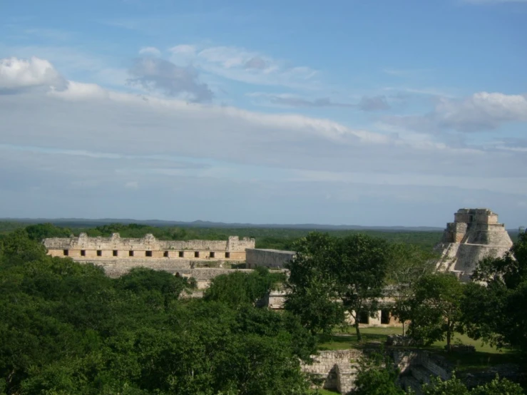 the ruins of a large castle sitting among the trees