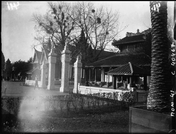 black and white po of several people sitting at a table outside a cafe