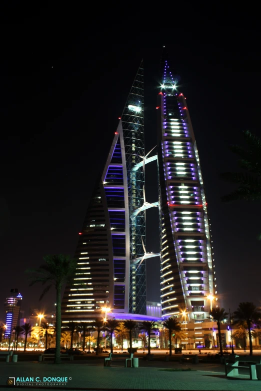 some very tall buildings at night time