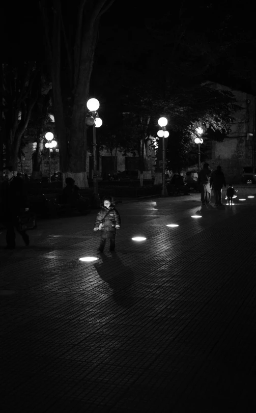 a person is sitting alone and on the ground at night