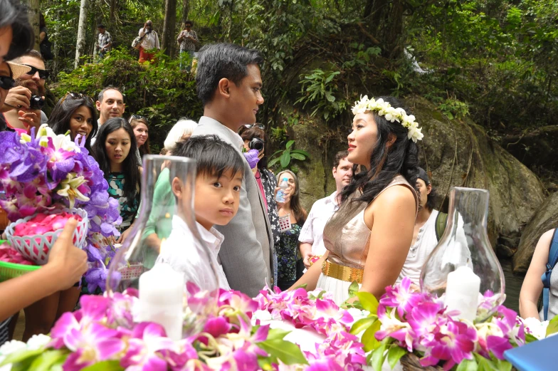 a group of people posing with a bunch of flowers