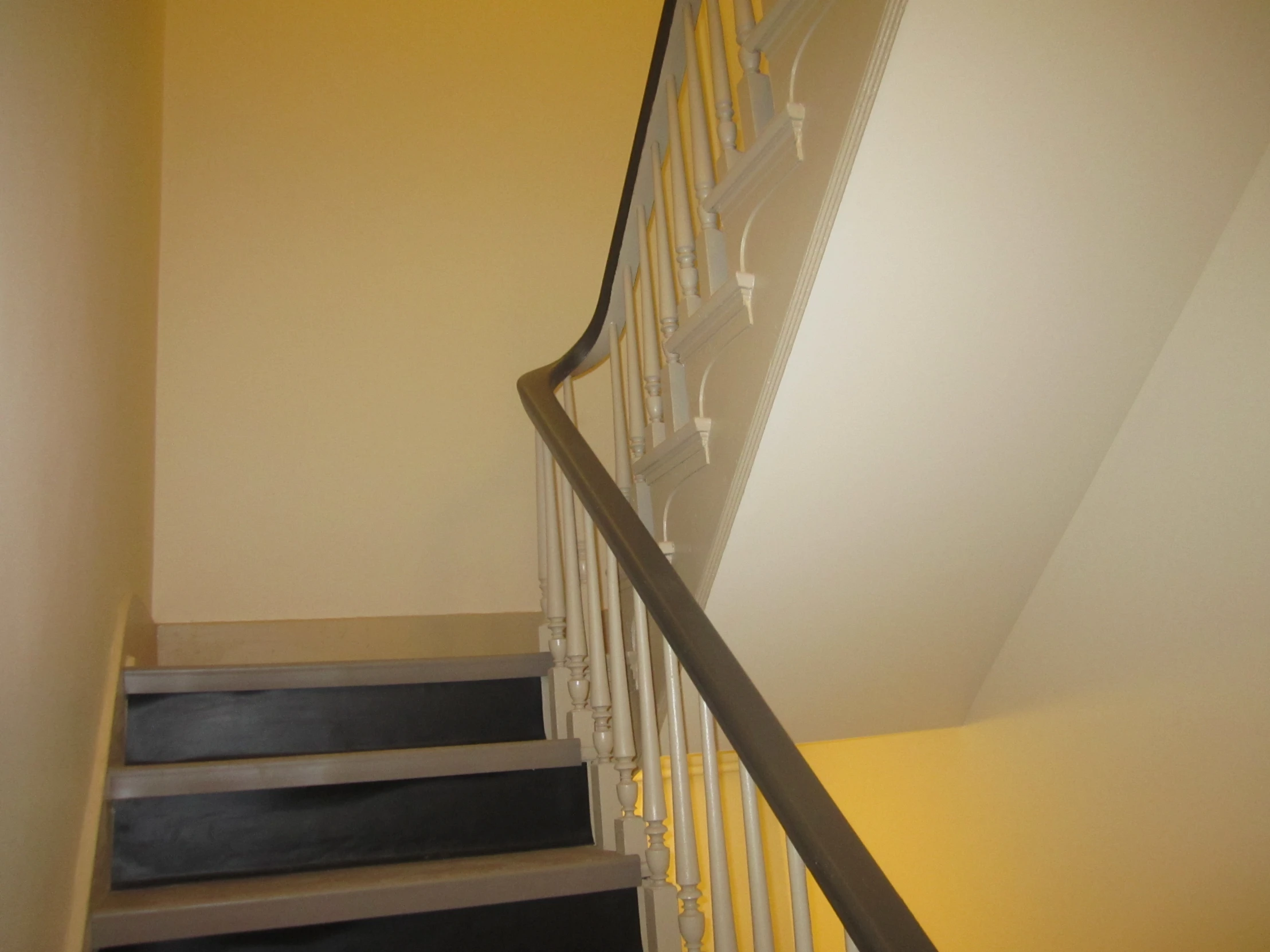 a white railing near some brown steps